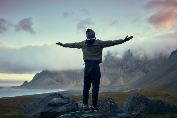 Majestic coastline. African ethnicity man admiring the view
