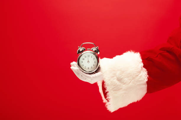 istock Santa holding an old alarm clock 1083596964