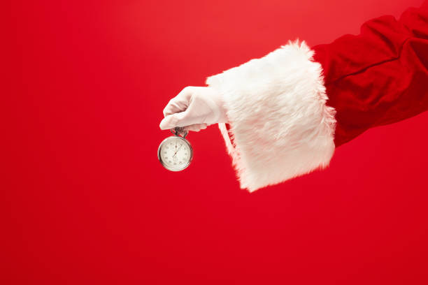 istock Santa holding a stopwatch in hand 1083596972