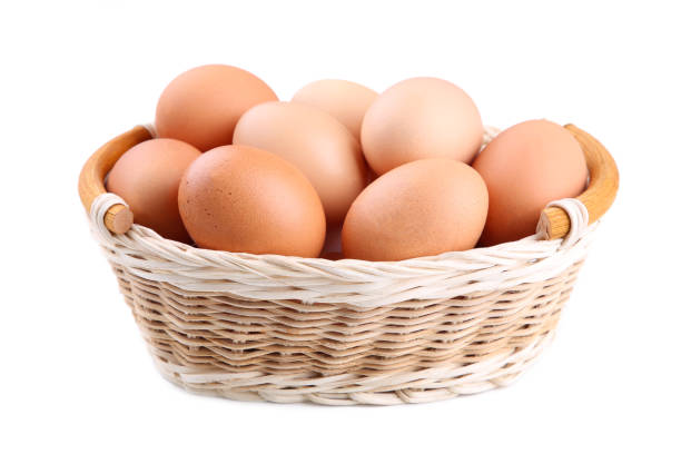 istock Fresh Chicken eggs in basket isolated on white, close up 1083597106