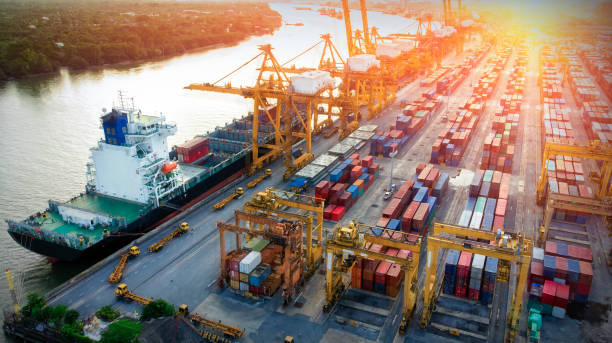 istock Logistics and transportation of Container Cargo ship and Cargo plane with working crane bridge in shipyard at sunrise, logistic import export and transport industry background 1083598162