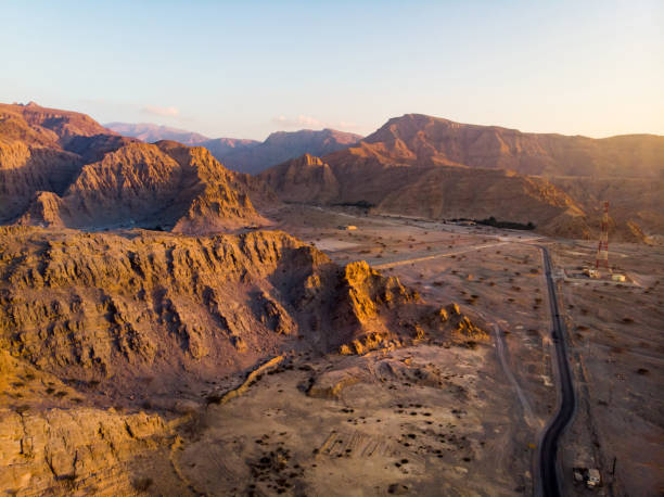 istock Desert road at sunset aerial view 1083600308