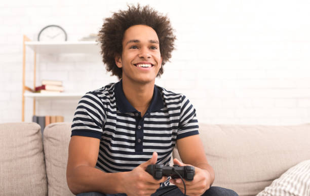 istock Online gaming concept. Guy playing football video game with joystick 1083603088