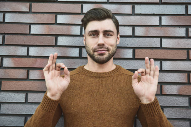 istock Closeup surprised man in eyeglasses looking at camera and open mouth on brick background. 1083609528