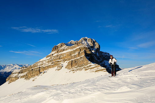 Man snow skier skiing at  Italian Alps Dolomite ski resort. Madonna di Campiglio italy. Europe.