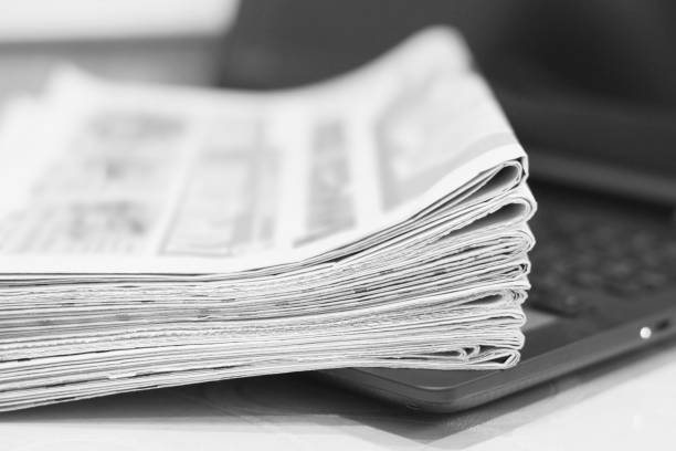 istock Newspapers and laptop 1083613140