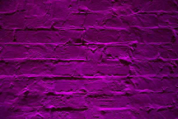 istock Grunge neon purple brick wall texture background. Magenta colored brick wall texture architexture pattern. 1083613144