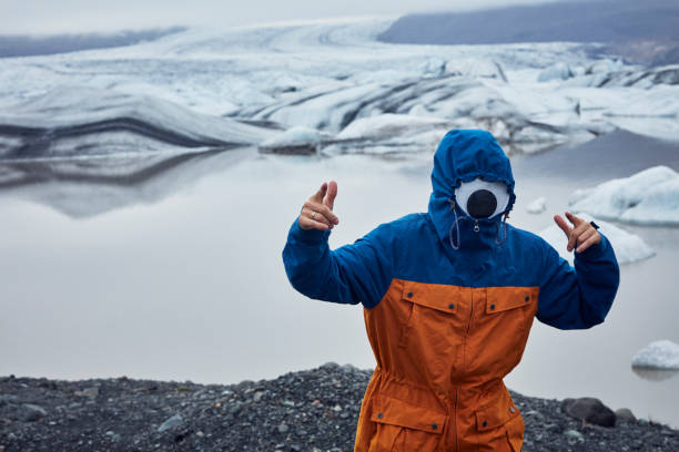 istock Pretending to be a cyclops. Man having fun at glacier lagoon 1083614844