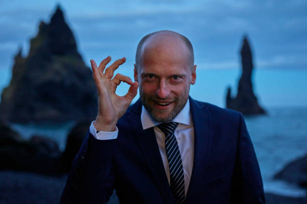 istock Businessman escaping from work. Black beach after sunset 1083614962