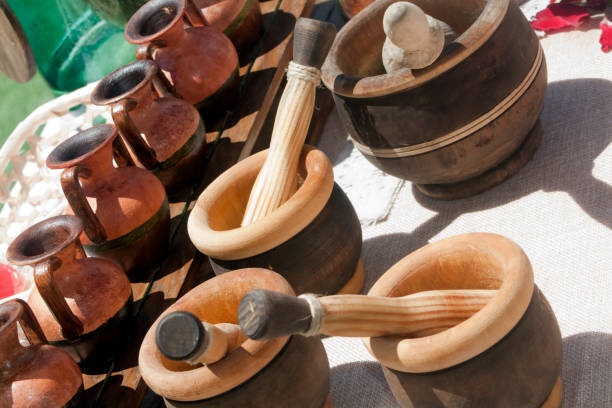 istock Wooden mortar and pestle, clay jars. 1083616974