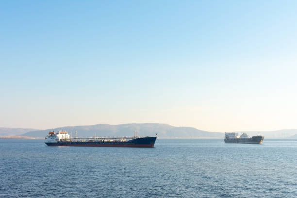 Two cargo ship on the background of mountains. Oil tanker anchored. At the top there is a place for your text.