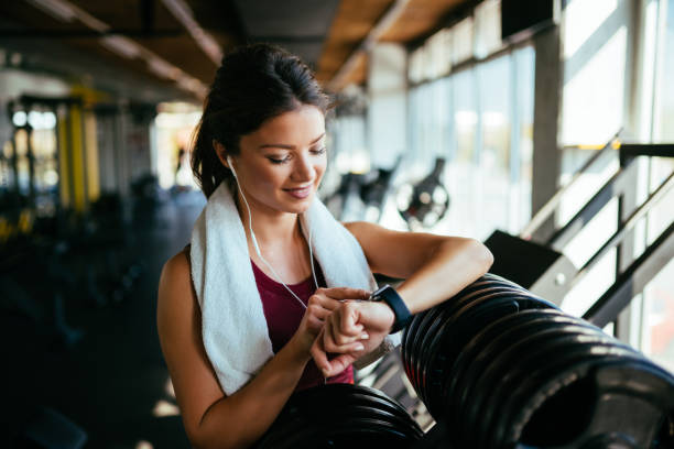 istock Athletic woman checking the time on wristwatch 1083619986