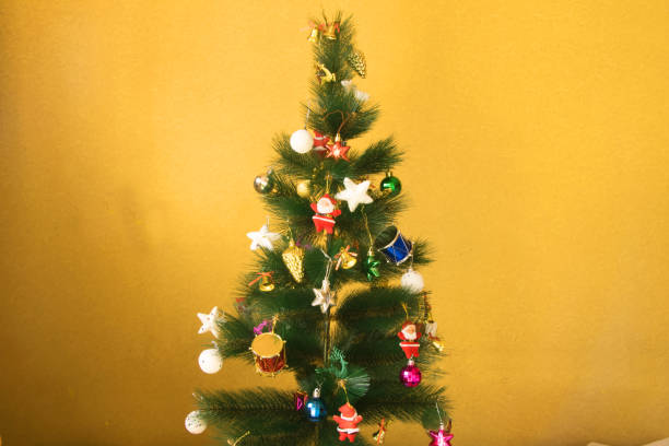 istock Image of christmas tree  and santa in yellow background 1083620058