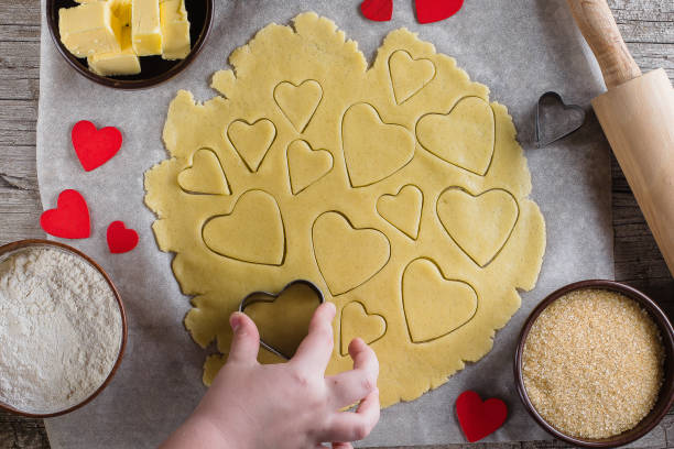 liebe herzkekse backen, für den valentinstag. ansicht von oben. die hände von kindern zu unterstützen, süßes gebäck. shortbread-plätzchen - cookie heart shape shortbread christmas stock-fotos und bilder