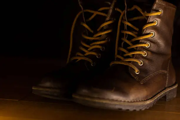 Photo of brown leather shoes on wooden floor