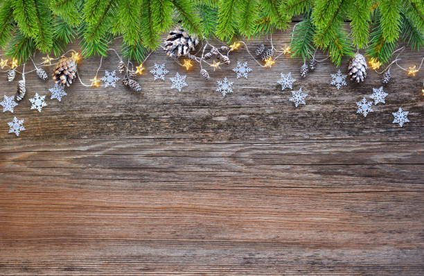 istock Christmas decorations and spruce branches on a wooden table. Festive  background. Top view, copy space. 1083624456