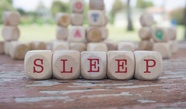 istock SLEEP word written on cube shape wooden blocks on wooden table. 1083625648