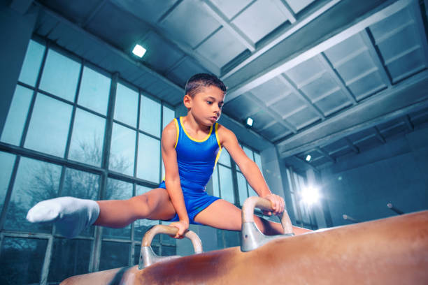 istock The sportsman performing difficult gymnastic exercise at gym. 1083625746