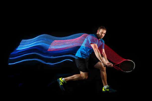 istock one caucasian man playing tennis player on black background 1083627654