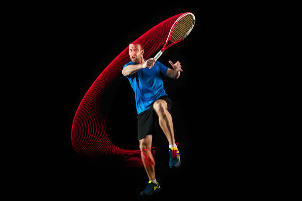 istock one caucasian man playing tennis player on black background 1083627684