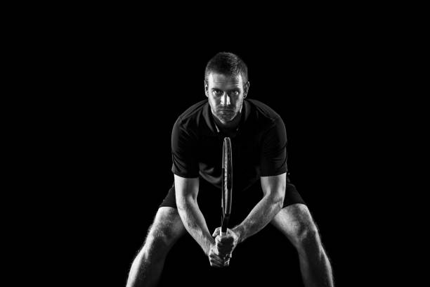 istock one caucasian man playing tennis player on black background 1083627696