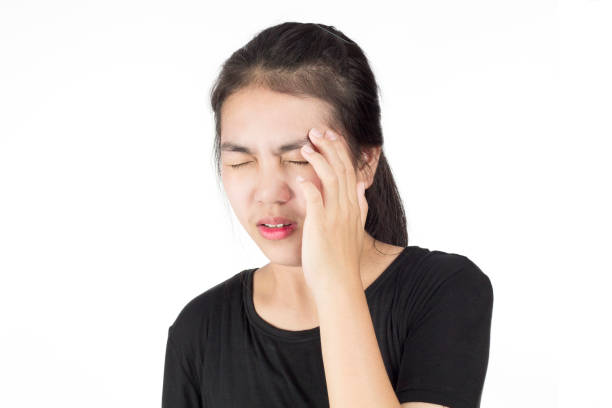 istock woman headache migraine 1083629572