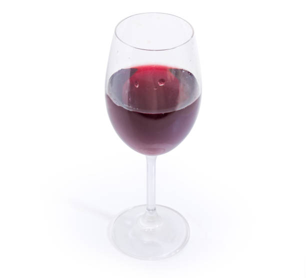istock Glass of red wine on a white background 1083630526