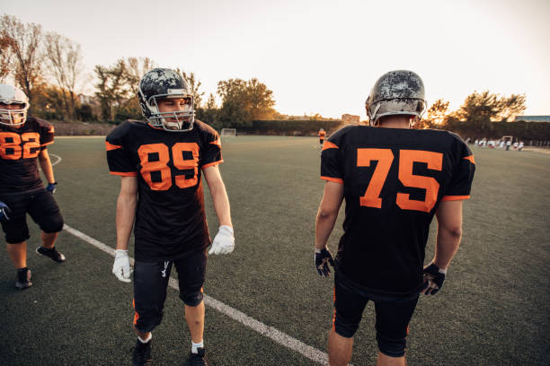 Group of men, American football team on training outdoors.