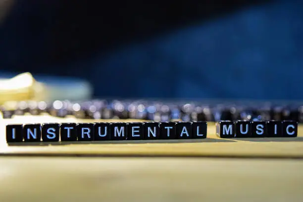 Photo of INSTRUMENTAL MUSIC concept wooden blocks on the table.