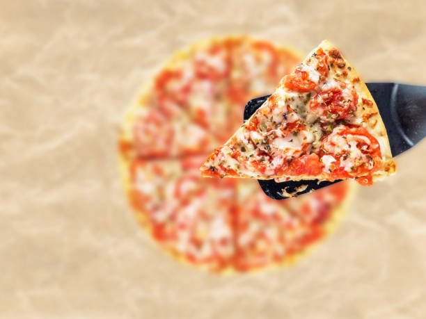 istock Pizza wedge above the blurred crumpled paper background 1083637192