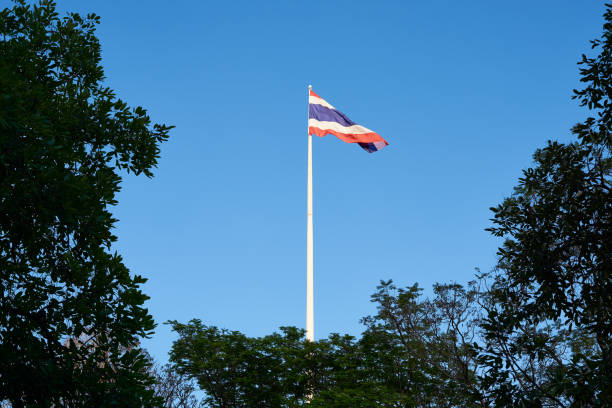 istock Thai flag waving on blue sky background 1083637908