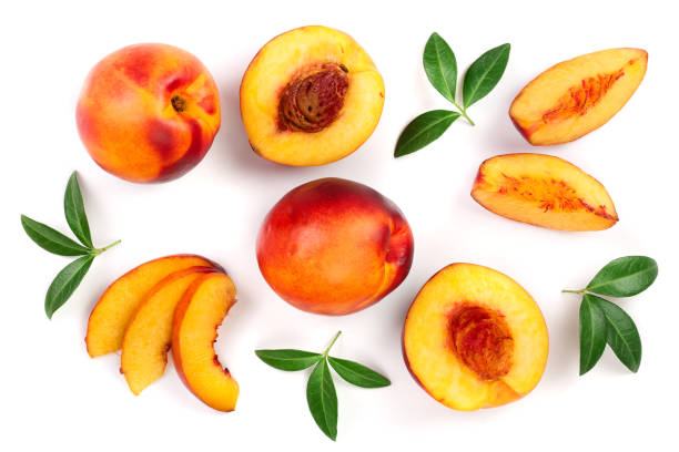 istock ripe nectarine with leaves isolated on white background. Top view. Flat lay pattern 1083638134