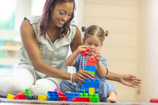 istock Teacher with preschool girl 1083642588