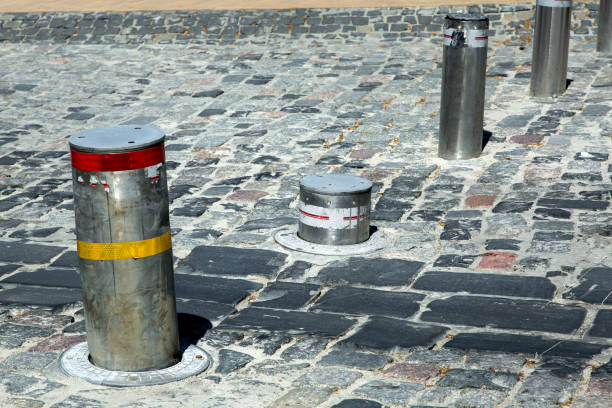 istock Retractable Electric Bollard Metallic hydraulic goes down under the ground for the opening of the passage for transport. 1083646708