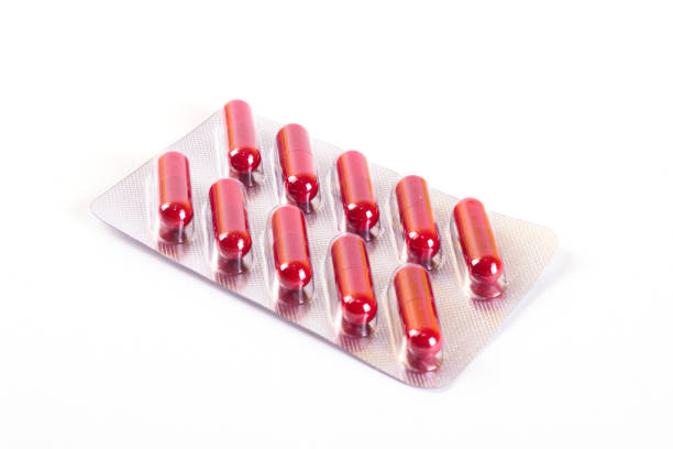 istock Red pills in a blister, isolated on white background 1083648400