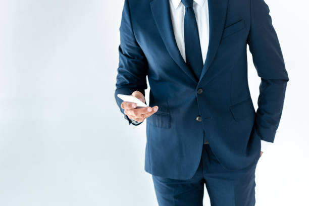 istock cropped image of businessman using smartphone isolated on white 1083649250