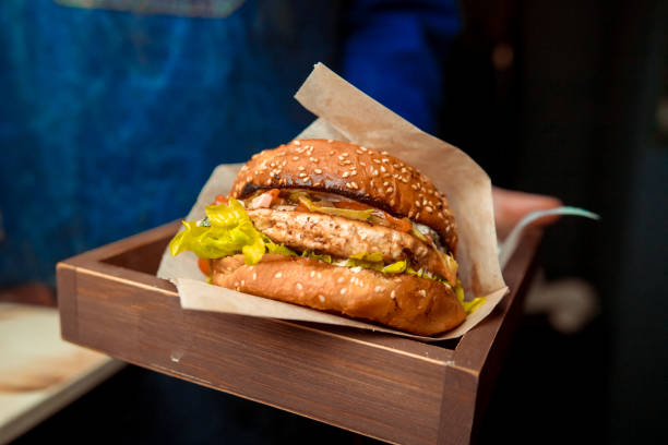 istock Delicious fresh homemade burger on a wooden table 1083650634