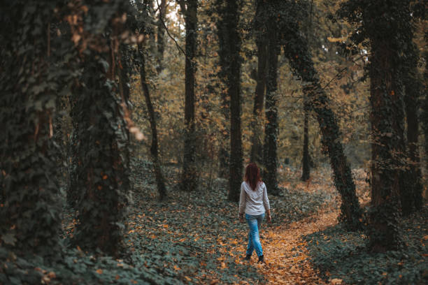 istock Women in autumn forest 1083659274