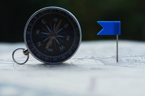 istock Compass and flag pins on blur vintage world map, journey concept, copy space 1083672108