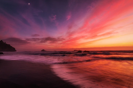 This is a color landscape photo of a vivid sunset over the Pacific Ocean.