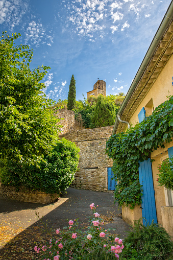 Lourmarin, Provence, Luberon, Vaucluse, France - Mai 30, 2017: Idyllic lane with a view of the old bell tower in Lourmarin,