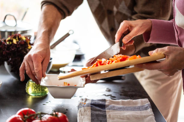 istock Seniors preparing vegetable salad in the kitchen 1083675076