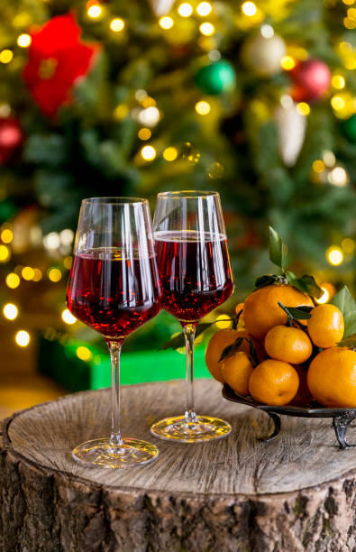 istock Champagne with mandarins at wood board, christmas tree behind 1083677366