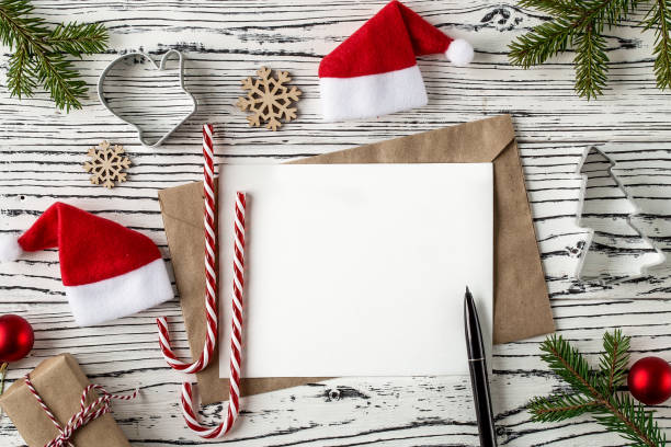 istock Christmas mail, envelopes with letters on a light wooden table. 1083678524