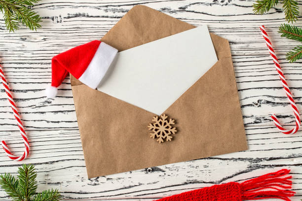 istock Christmas mail, envelopes with letters on wooden table. 1083678596