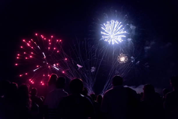 istock Crowd watching fireworks and celebrating new year eve 1083678728