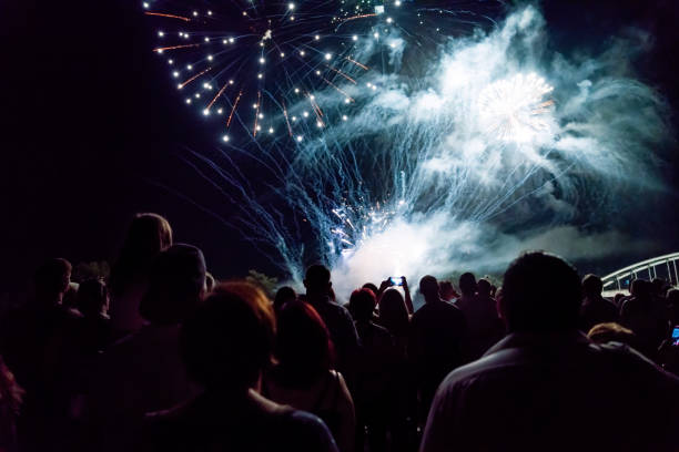 istock New year concept - cheering crowd and fireworks 1083678800
