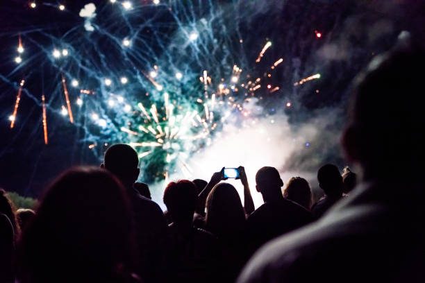 istock Crowd watching fireworks and celebrating new year eve 1083678804