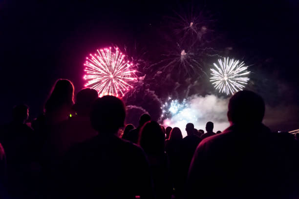 istock Crowd watching fireworks and celebrating new year eve 1083678808