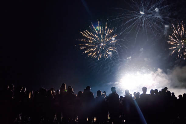 istock Crowd watching fireworks and celebrating new year eve 1083678820